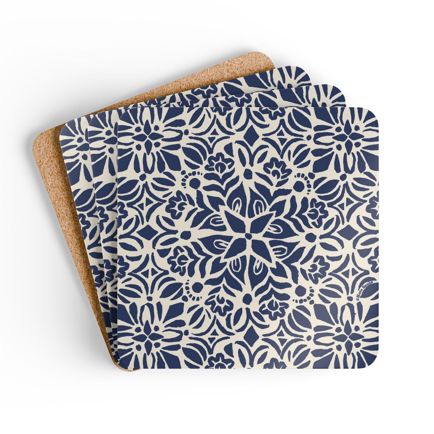Set of three blue and white patterned coasters with cork backing on a white background