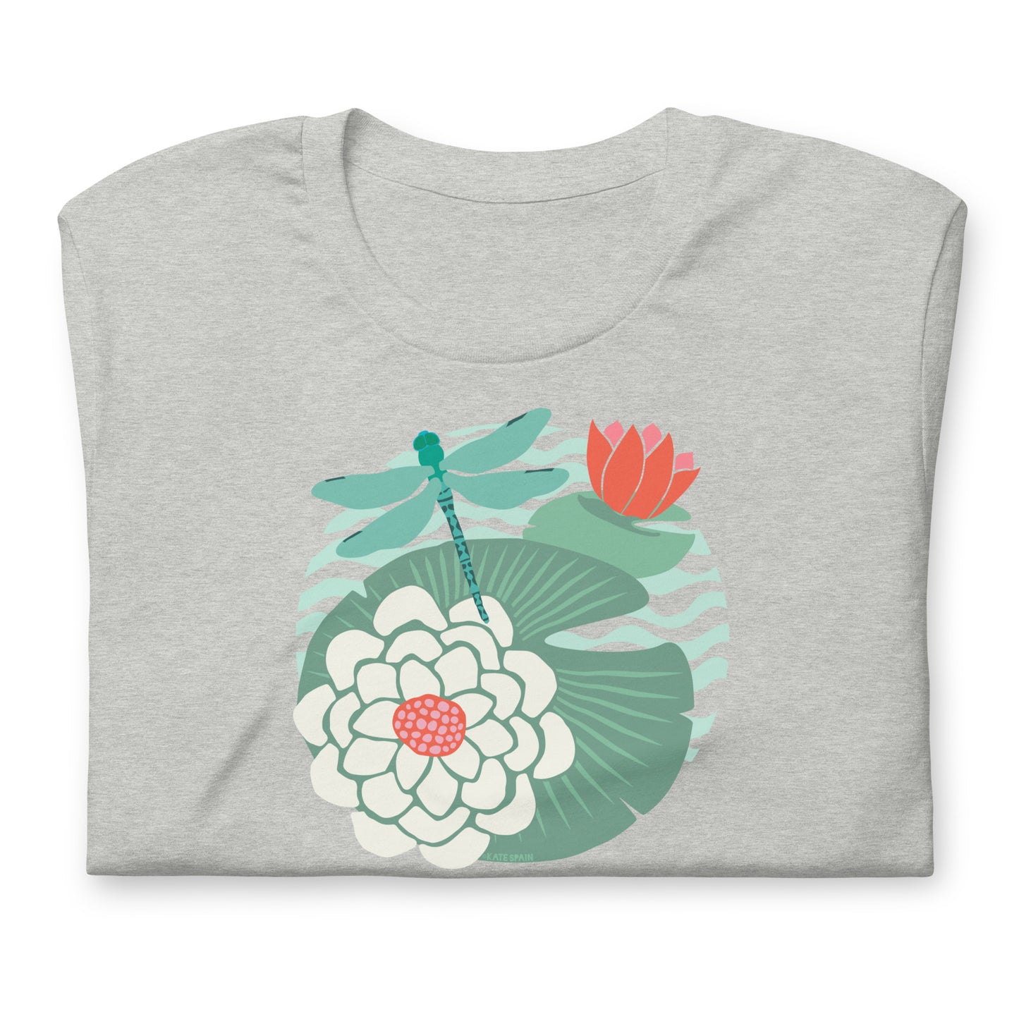 Illustrated dragonfly hovering over a green lily pad with pink and white water lily flowers on a calm pond, printed on a soft athletic gray crewneck t-shirt. Shown folded for scale.