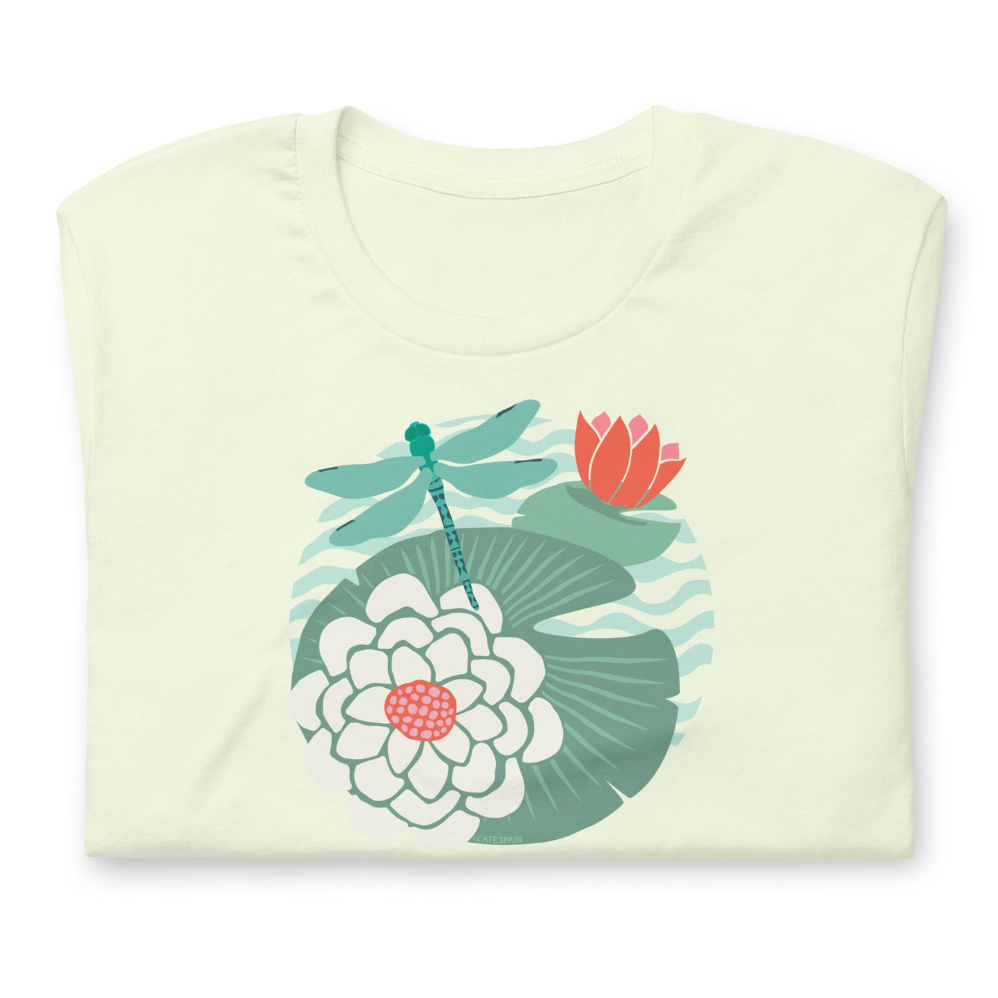 Illustrated dragonfly hovering over a green lily pad with pink and white water lily flowers on a calm pond, printed on a soft pale citron colored premium quality crewneck t-shirt. Shown folded for scale.