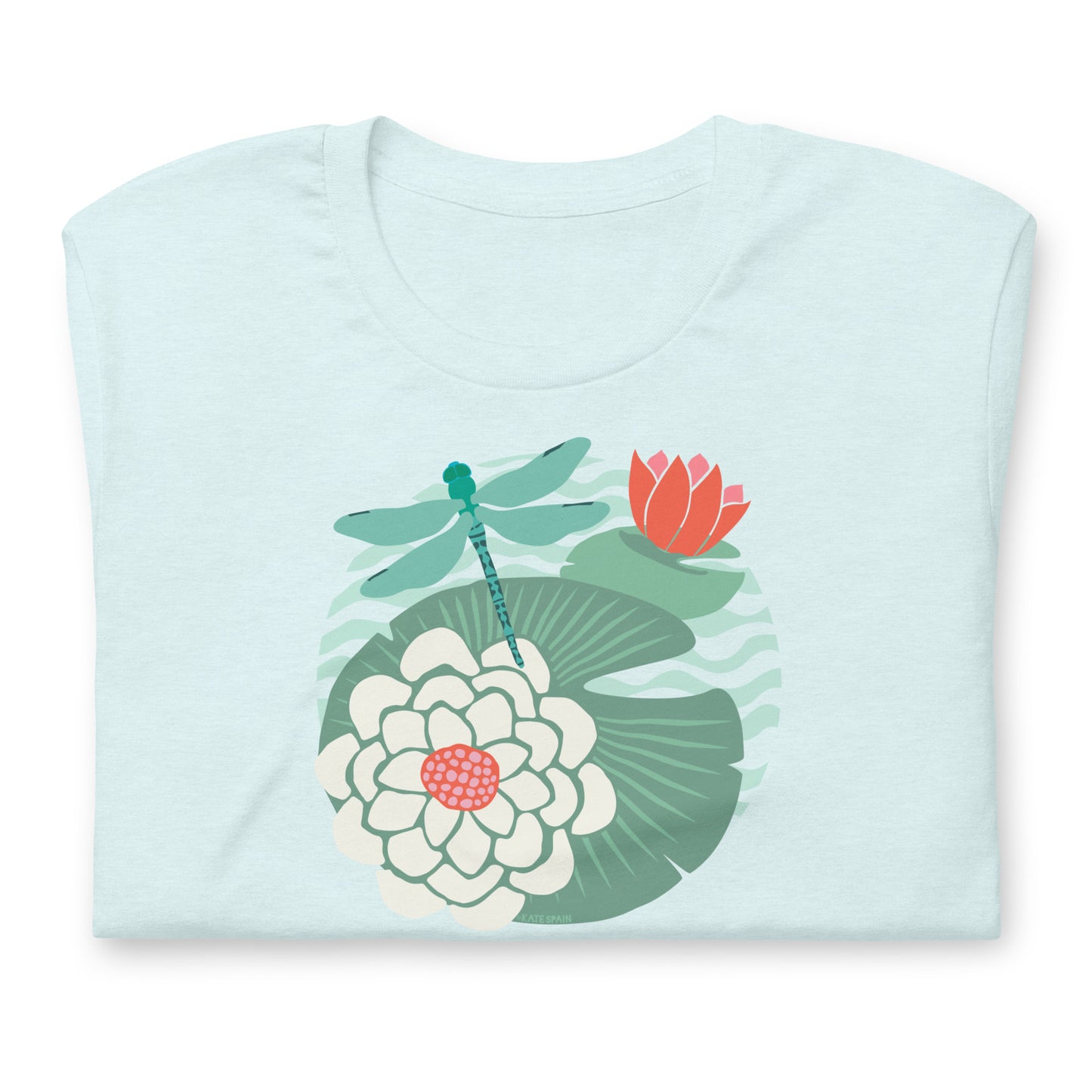 Illustrated dragonfly hovering over a green lily pad with pink and white water lily flowers on a calm pond, printed on a soft pale ice blue colored premium quality crewneck t-shirt. Shown folded for scale.