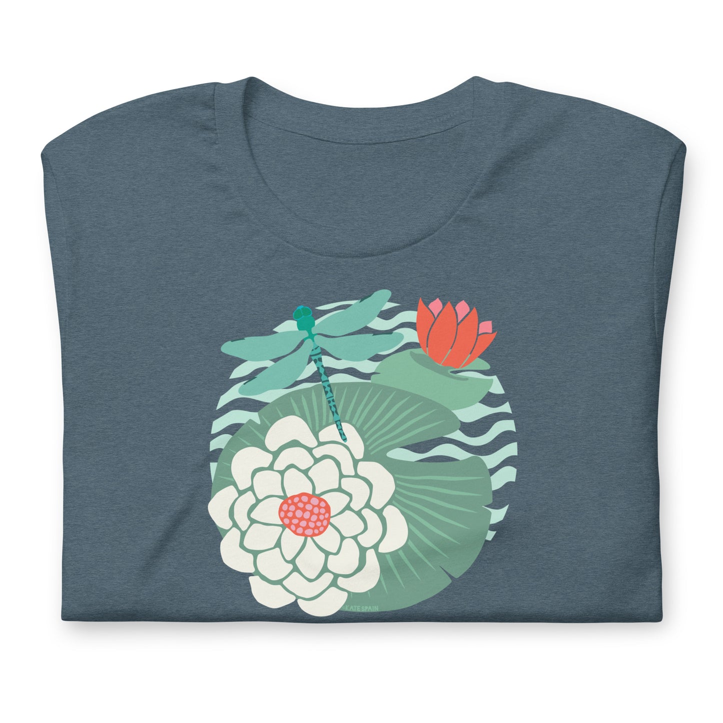 Illustrated dragonfly hovering over a green lily pad with pink and white water lily flowers on a calm pond, printed on a soft gray-blue colored premium quality crewneck t-shirt. Shown folded for scale.