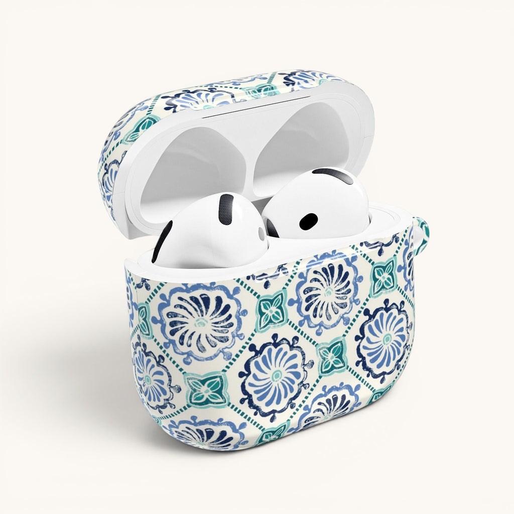 floriori Horizon Blue Tile AirPods case with a navy and teal Moroccan-inspired floral medallion print on white. Earbuds fit snugly in case