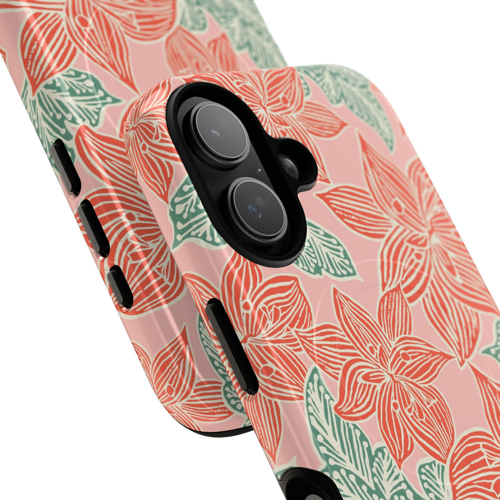 Hibiscus Coral MagSafe iPhone 17 Glossy Case — angled view showing slim profile; blush pink case with coral red hibiscus flowers and teal-green leaves in bold botanical linework