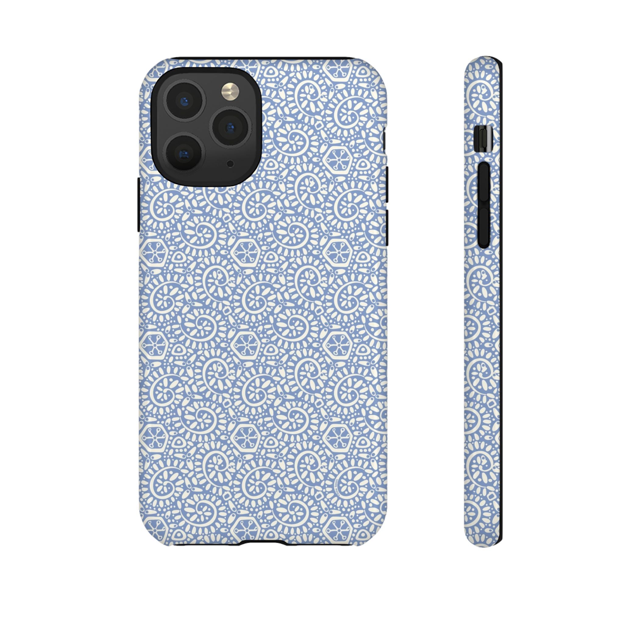 Canto Swirls Mist iPhone 11 Pro Glossy Case — periwinkle blue hard case covered in an intricate folk-art medallion pattern of radiating white circular motifs, dot clusters, and geometric centers