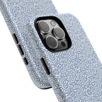 Canto Swirls Mist MagSafe iPhone 16 Pro Max Glossy Case — angled view showing slim profile; periwinkle blue folk-art medallion pattern of radiating white circular motifs, dot clusters, and geometric centers