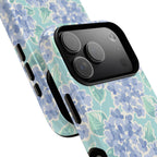 Nantucket Hydrangea MagSafe iPhone Case – lifestyle angled view of button, ports, and camera cutout. Shows raised bezel edges around camera lens.