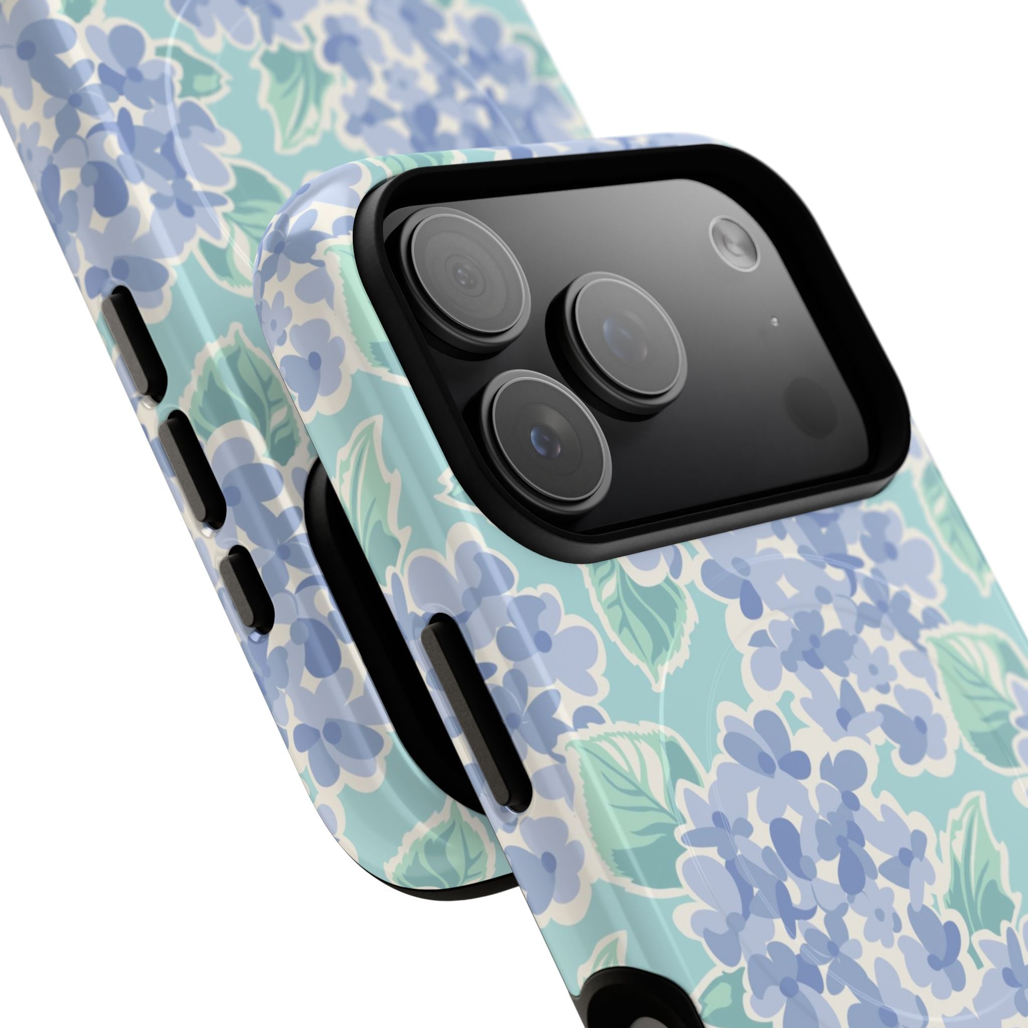 Nantucket Hydrangea MagSafe iPhone Case – lifestyle angled view of button, ports, and camera cutout. Shows raised bezel edges around camera lens.