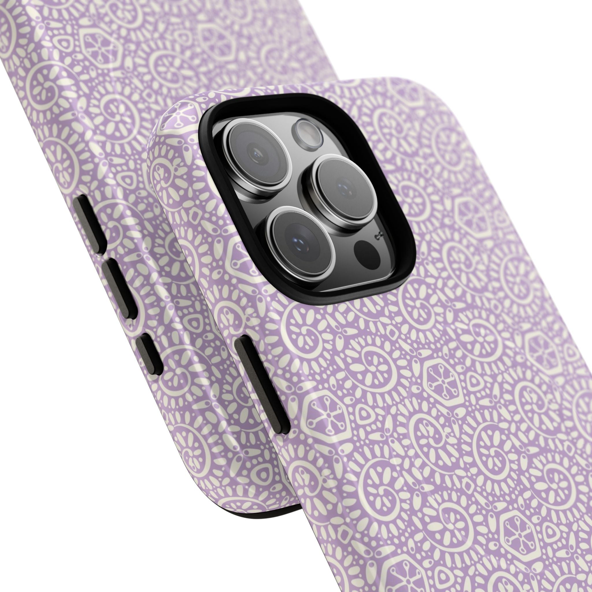 Canto Swirls Lavender MagSafe iPhone 16 Pro Max Glossy Case — angled view showing slim profile; lavender folk-art medallion pattern of radiating circular motifs, dot clusters, and geometric centers