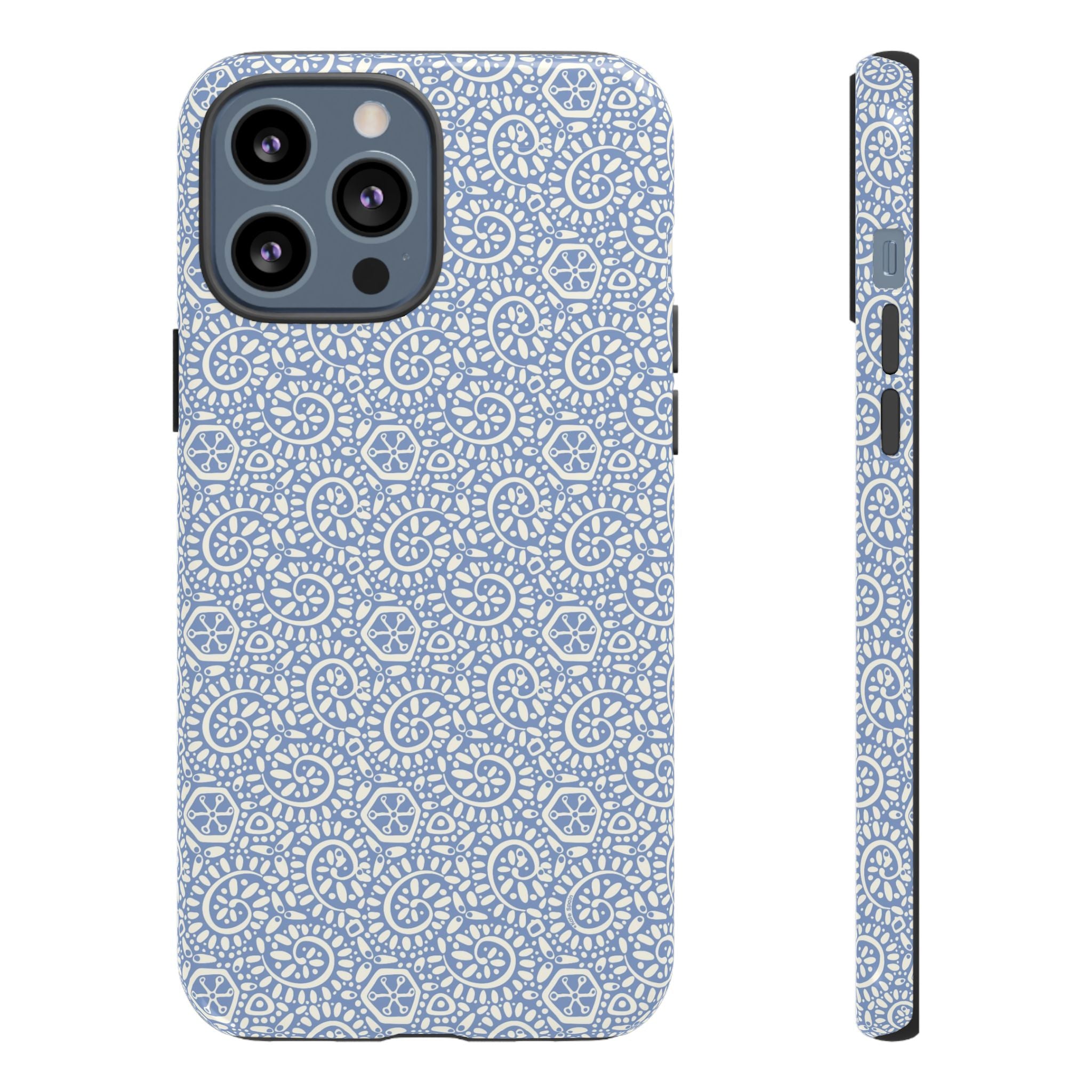 Canto Swirls Mist iPhone 13 Pro Max Glossy Case — periwinkle blue hard case covered in an intricate folk-art medallion pattern of radiating white circular motifs, dot clusters, and geometric centers