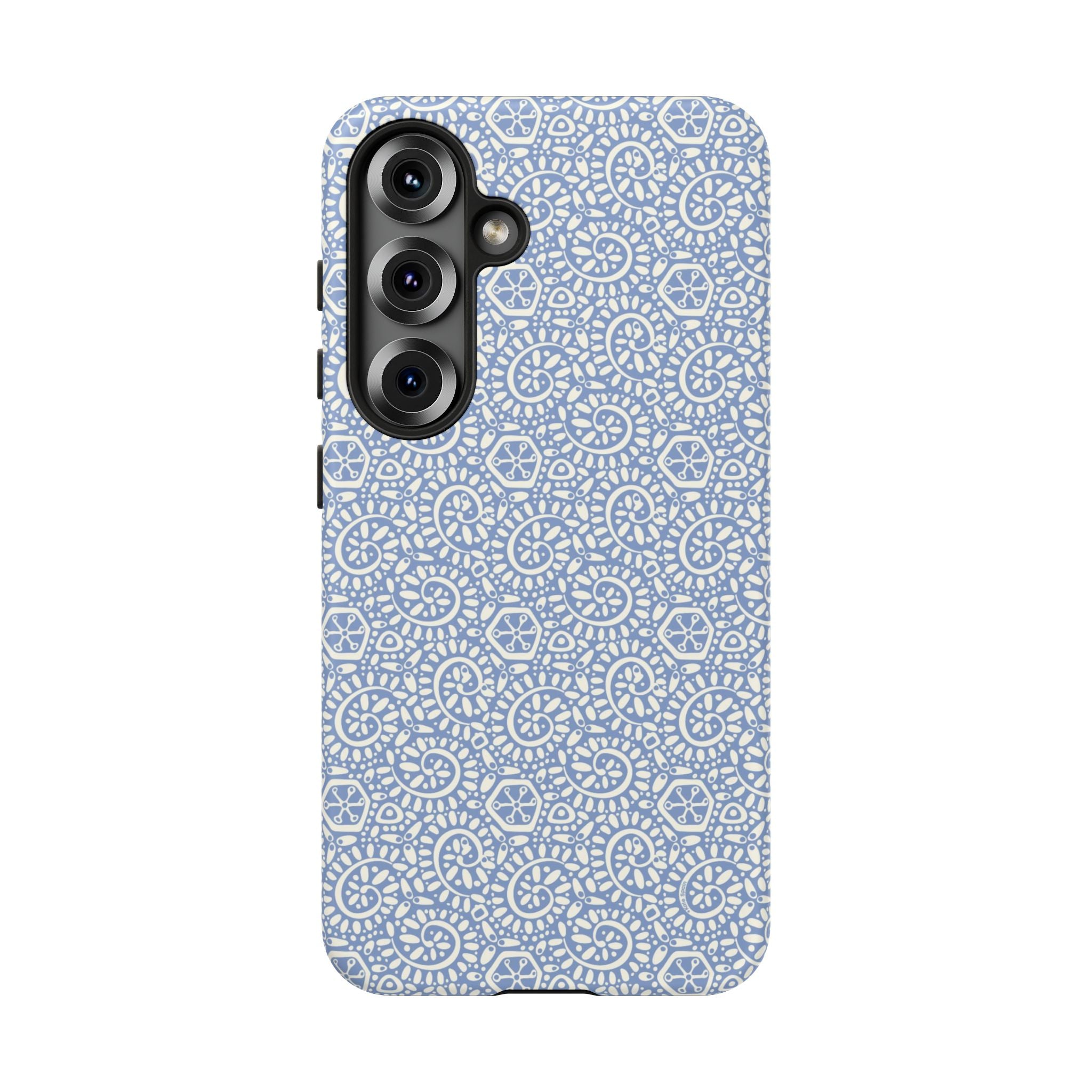 Canto Swirls Mist Samsung Galaxy S25 Matte Case — periwinkle blue hard case covered in an intricate folk-art medallion pattern of radiating white circular motifs, dot clusters, and geometric centers