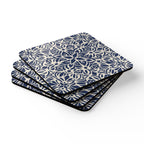 Set of four blue and white patterned coasters on a white background