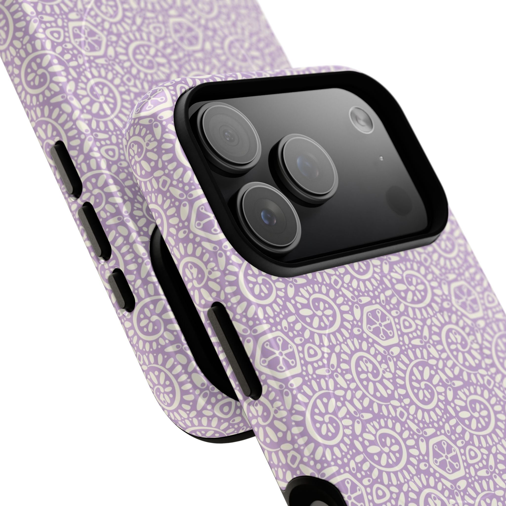 Canto Swirls Lavender MagSafe iPhone 17 Pro Max Glossy Case — angled view showing slim profile; lavender folk-art medallion pattern of radiating circular motifs, dot clusters, and geometric centers