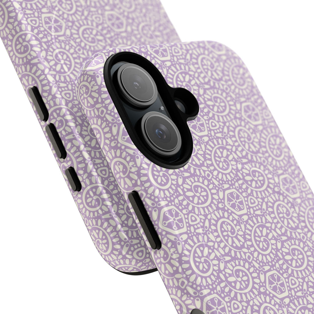 Canto Swirls Lavender MagSafe iPhone 17 Glossy Case — angled view showing slim profile; lavender folk-art medallion pattern of radiating circular motifs, dot clusters, and geometric centers