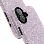 Canto Swirls Lavender MagSafe iPhone 17 Glossy Case — angled view showing slim profile; lavender folk-art medallion pattern of radiating circular motifs, dot clusters, and geometric centers
