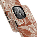 Vintage Bloom Sienna iPhone 16 Pro Max case – Glossy | sienna ground, large-scale cream clematis print, angled view showing camera cutout and buttons, dual-layer protection