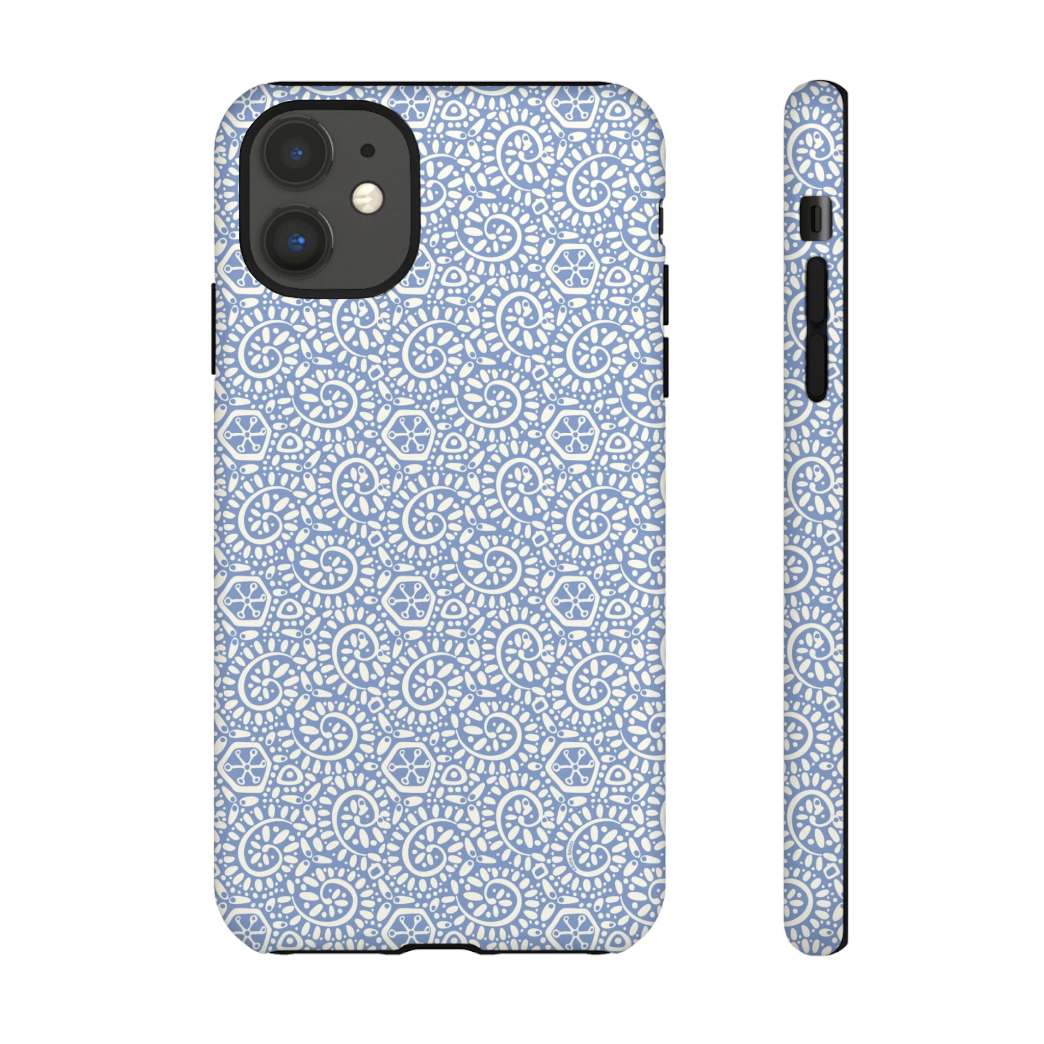 Canto Swirls Mist iPhone 11 Matte Case — periwinkle blue hard case covered in an intricate folk-art medallion pattern of radiating white circular motifs, dot clusters, and geometric centers