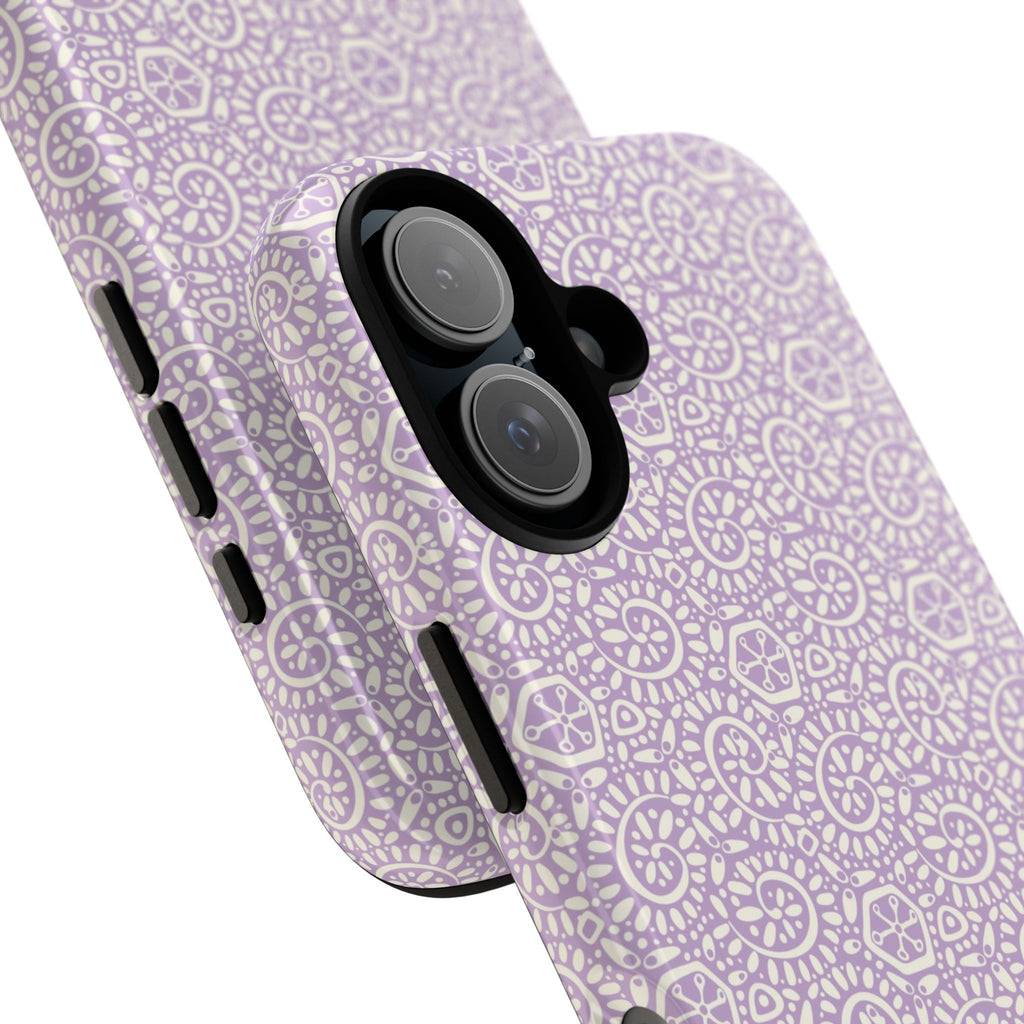 Canto Swirls Lavender iPhone 17 Glossy Case — angled view showing slim profile; lavender folk-art medallion pattern of radiating circular motifs, dot clusters, and geometric centers