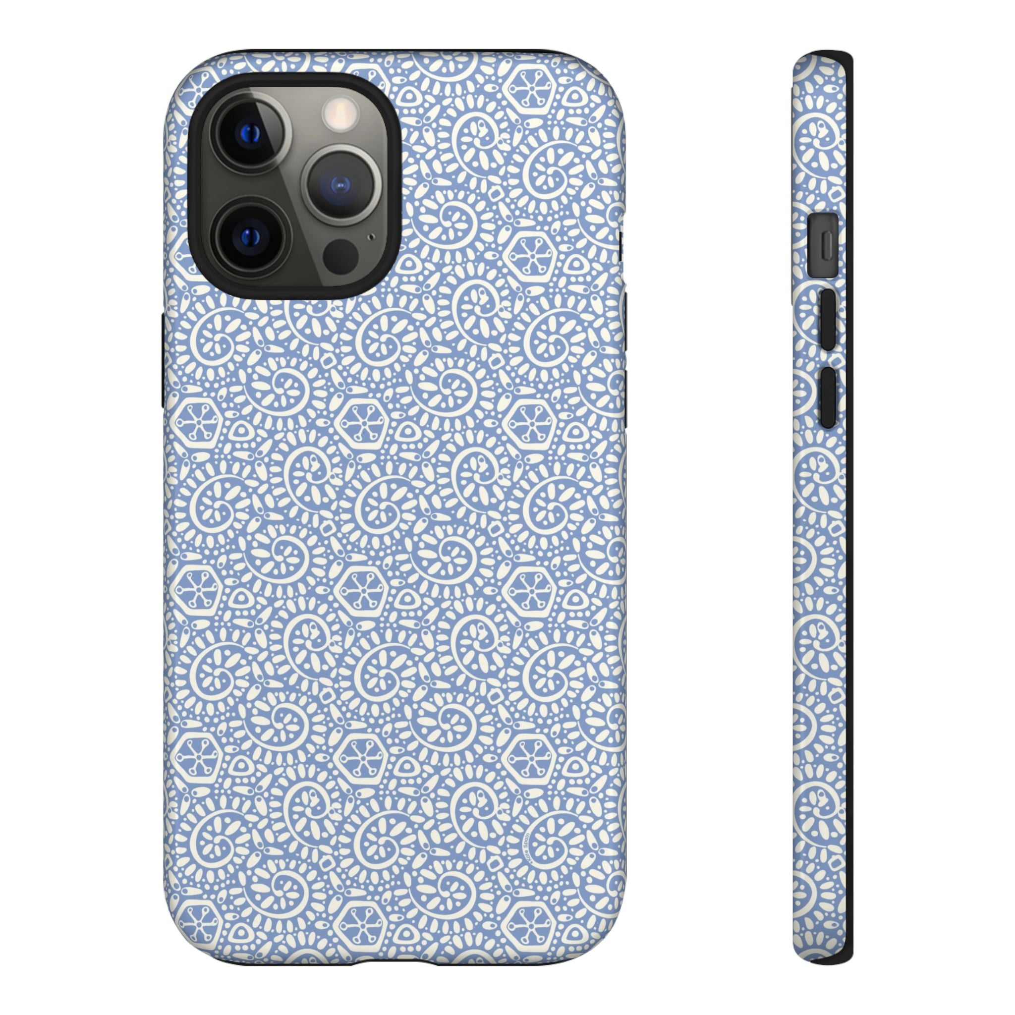 Canto Swirls Mist iPhone 12 Pro Max Glossy Case — periwinkle blue hard case covered in an intricate folk-art medallion pattern of radiating white circular motifs, dot clusters, and geometric centers