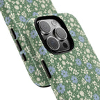 Petaline Green MagSafe iPhone 17 Case – Glossy | cream and periwinkle blue ditsy floral print on a sage green ground | angled view closeup of camera cutout and buttons