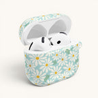 floriori Daisies AirPods Gen 4 case featuring summer white daisies with yellow centers on an aqua background with green leaves printed on glossy polycarbonate shell. Open with earbuds.