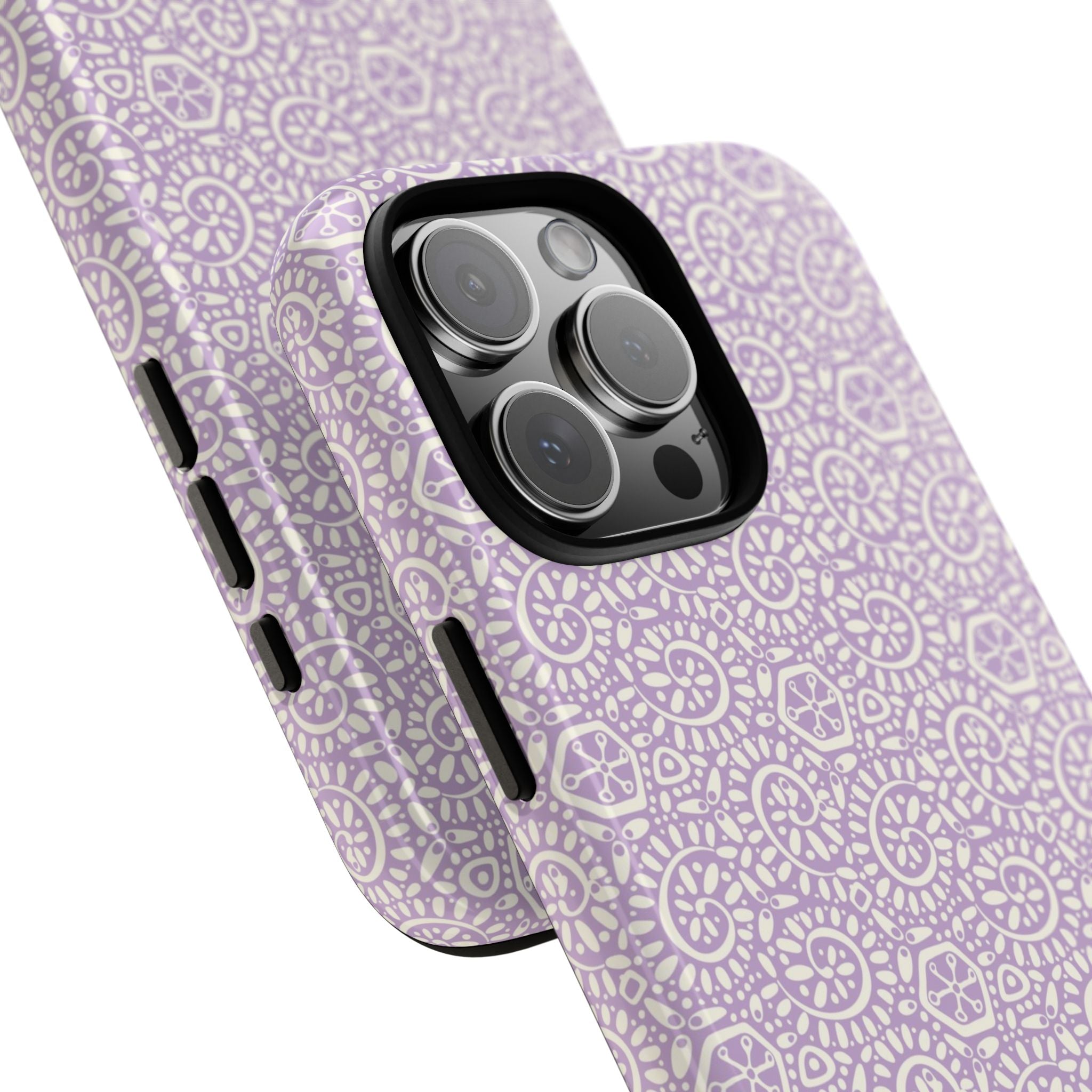 Canto Swirls Lavender iPhone 16 Pro Max Glossy Case — angled view showing slim profile; lavender folk-art medallion pattern of radiating circular motifs, dot clusters, and geometric centers
