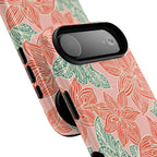 Hibiscus Coral MagSafe iPhone 17 Air Glossy Case — angled view showing slim profile; blush pink case with coral red hibiscus flowers and teal-green leaves in bold botanical linework