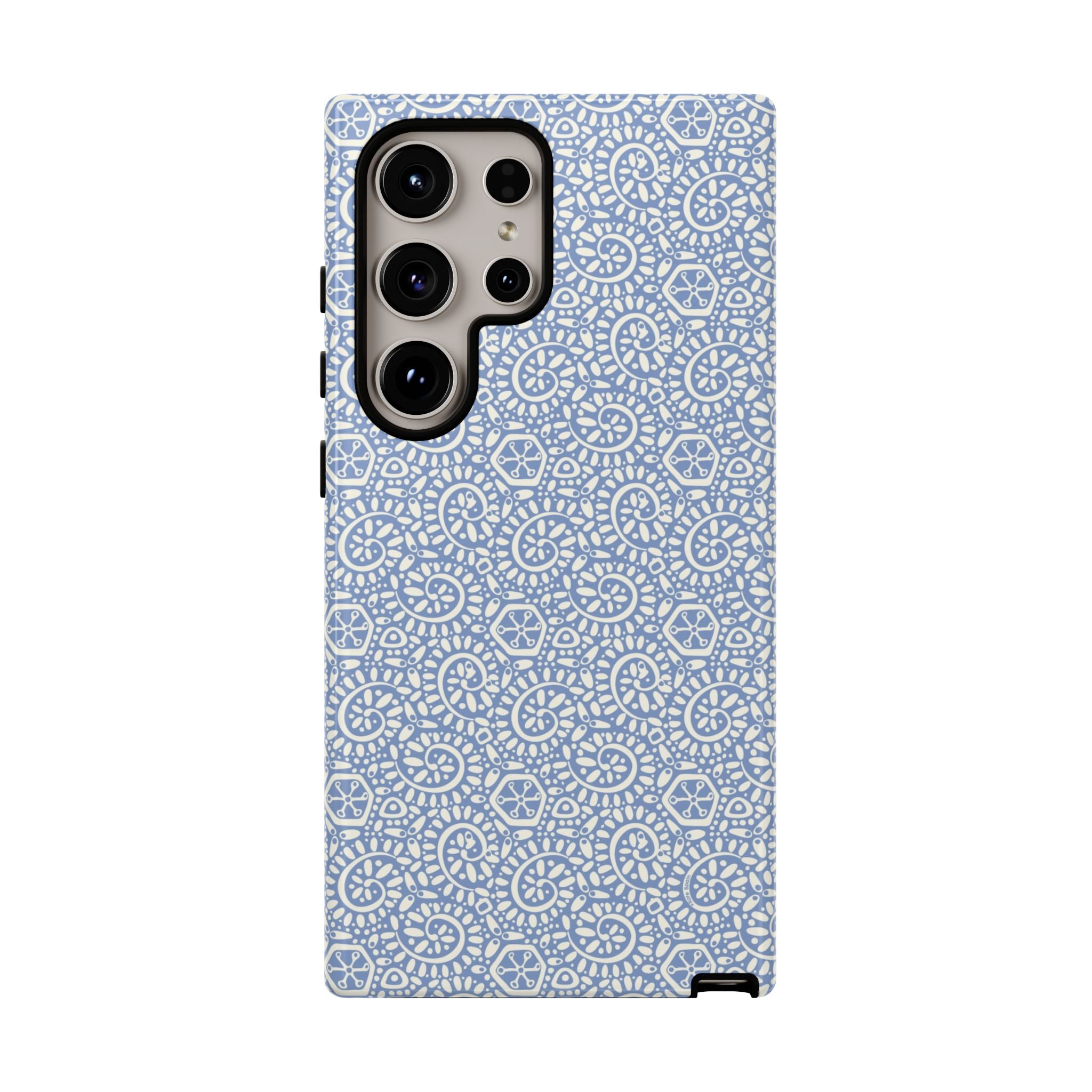 Canto Swirls Mist Samsung Galaxy S24 Ultra Glossy Case — periwinkle blue hard case covered in an intricate folk-art medallion pattern of radiating white circular motifs, dot clusters, and geometric centers