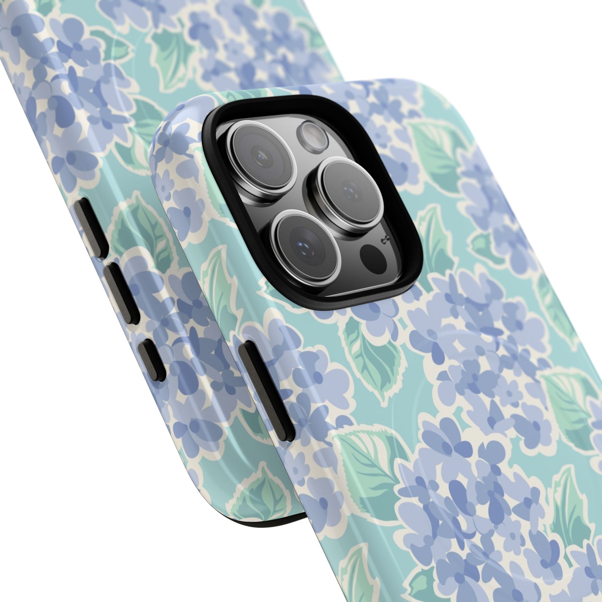 Nantucket Hydrangea MagSafe iPhone Case – lifestyle angled view of button, ports, and camera cutout. Shows raised bezel edges around camera lens.