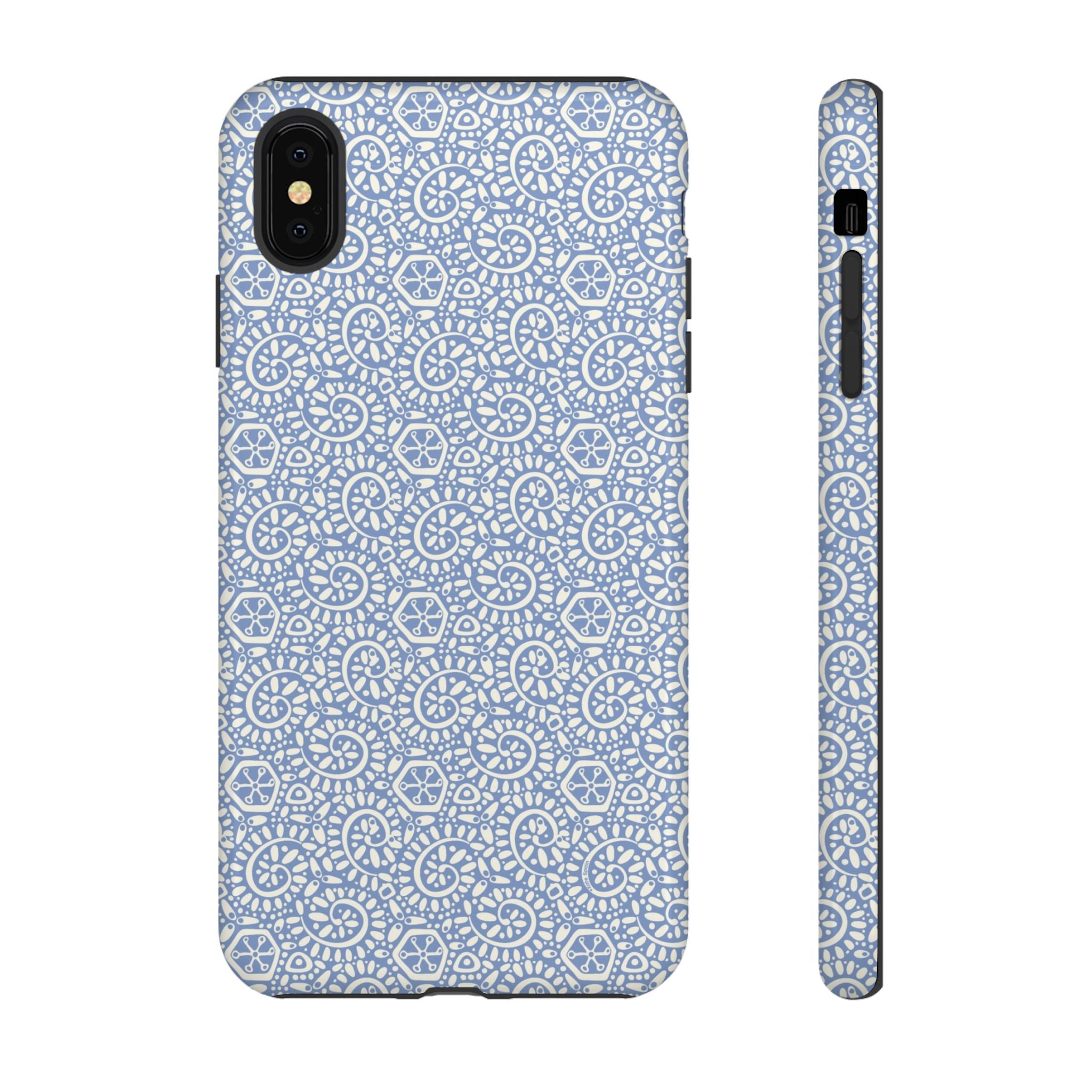 Canto Swirls Mist iPhone XS Max Glossy Case — periwinkle blue hard case covered in an intricate folk-art medallion pattern of radiating white circular motifs, dot clusters, and geometric centers