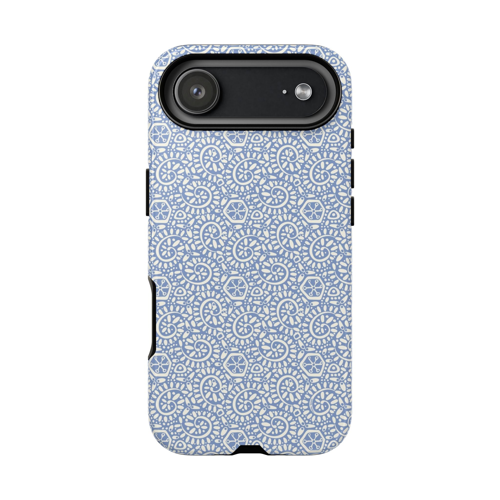 Canto Swirls Mist iPhone 17 Matte Case — periwinkle blue hard case covered in an intricate folk-art medallion pattern of radiating white circular motifs, dot clusters, and geometric centers