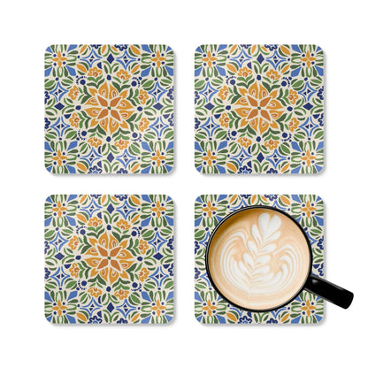 Set of four colorful patterned coasters with a cup of coffee on one coaster.