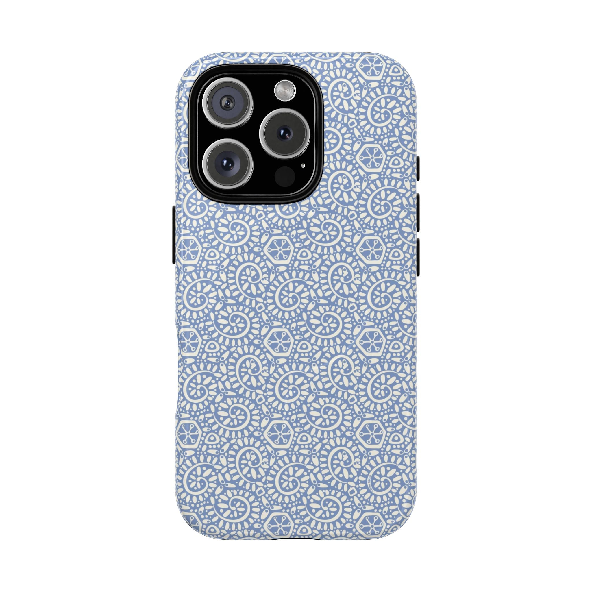 Canto Swirls Mist MagSafe iPhone 16 Pro Glossy Case — periwinkle blue hard case covered in an intricate folk-art medallion pattern of radiating white circular motifs, dot clusters, and geometric centers