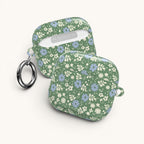 AirPods Gen 4 case – Glossy | periwinkle and cream ditsy flowers on sage green ground — side view with keychain ring attached