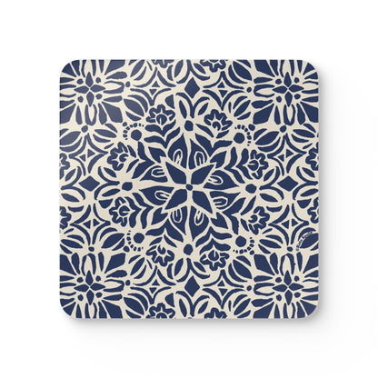 Square beverage coaster with blue floral pattern on a white background