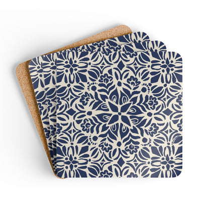 Set of three blue and white patterned coasters with cork backing on a white background