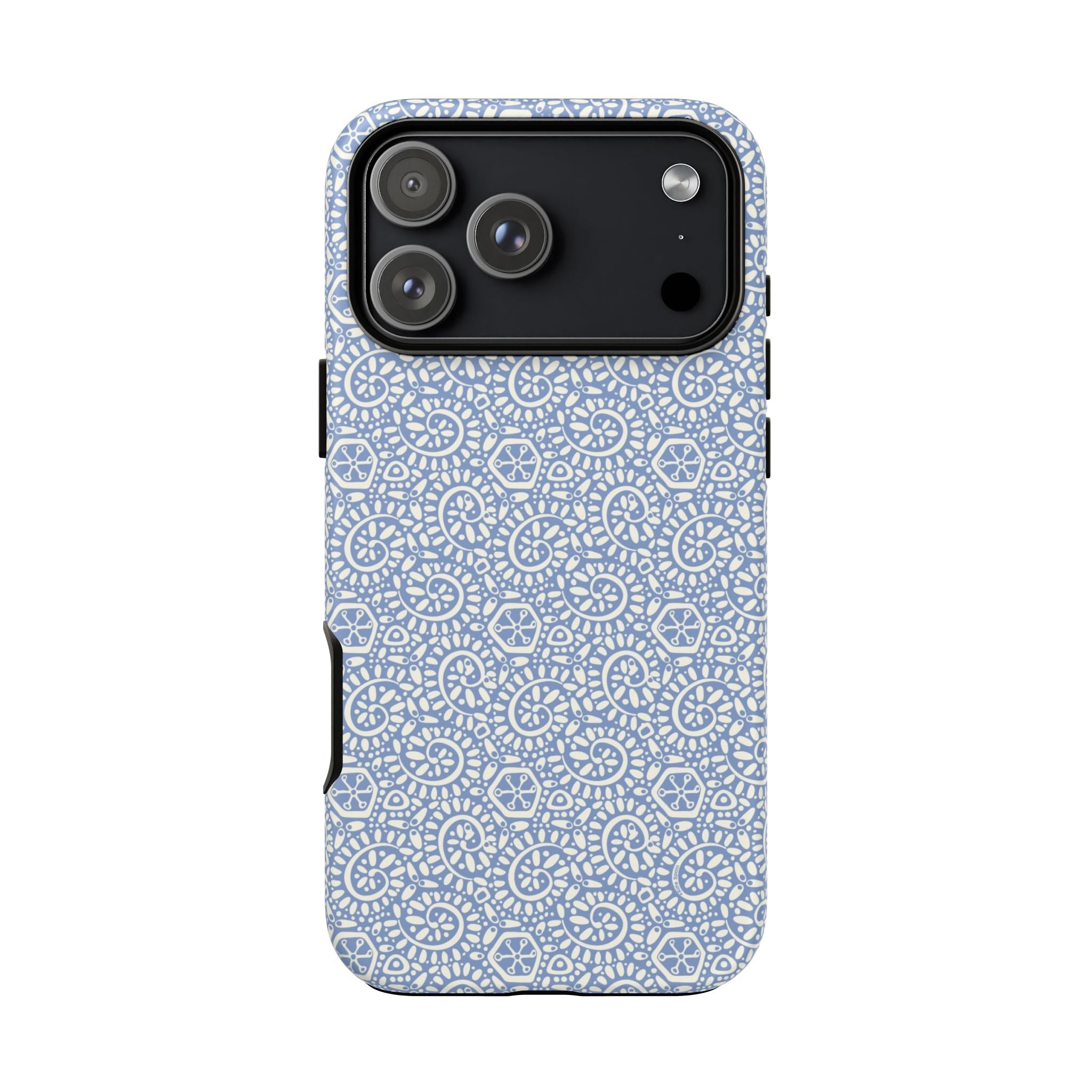 Canto Swirls Mist iPhone 17 Pro Max Matte Case — periwinkle blue hard case covered in an intricate folk-art medallion pattern of radiating white circular motifs, dot clusters, and geometric centers