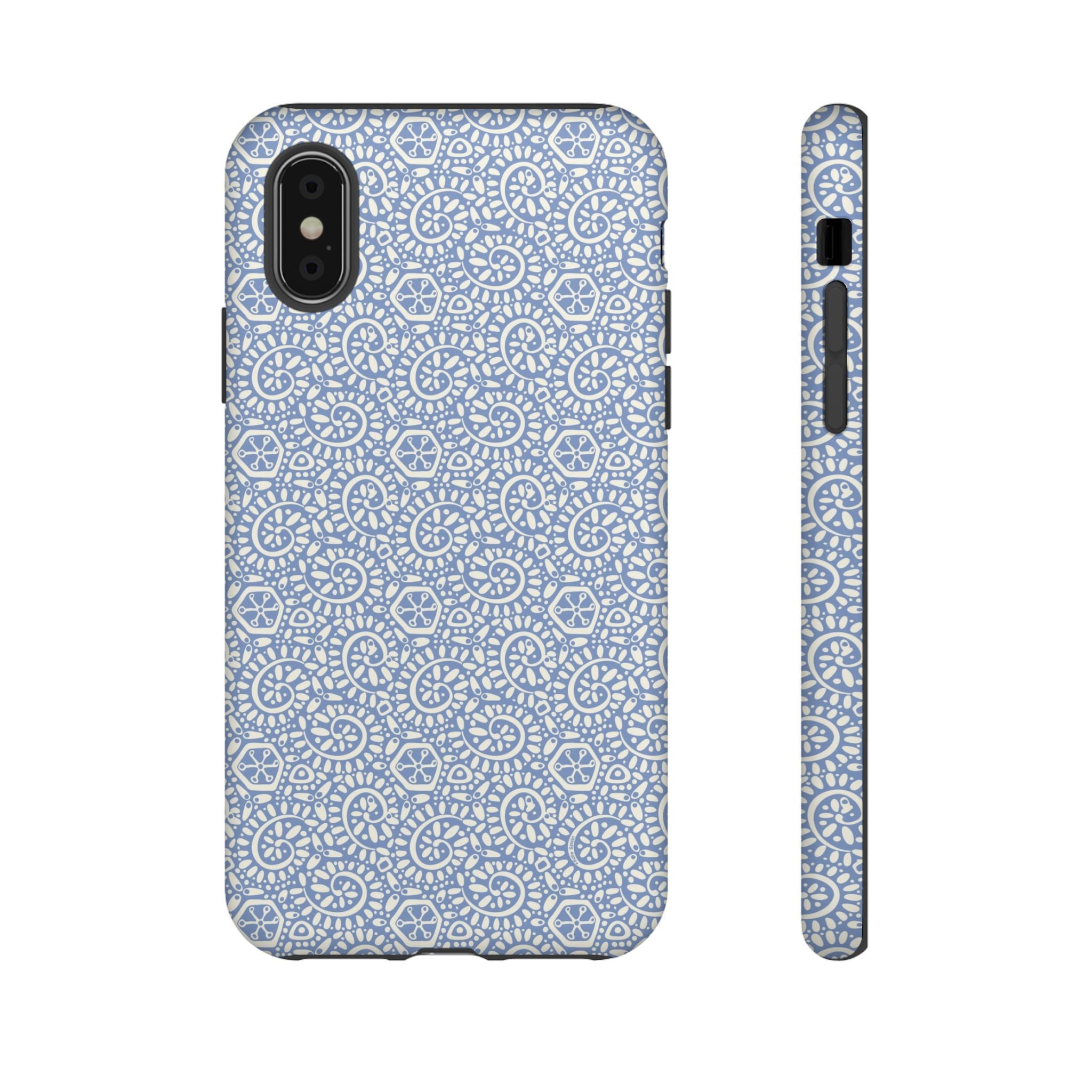 Canto Swirls Mist iPhone X Matte Case — periwinkle blue hard case covered in an intricate folk-art medallion pattern of radiating white circular motifs, dot clusters, and geometric centers