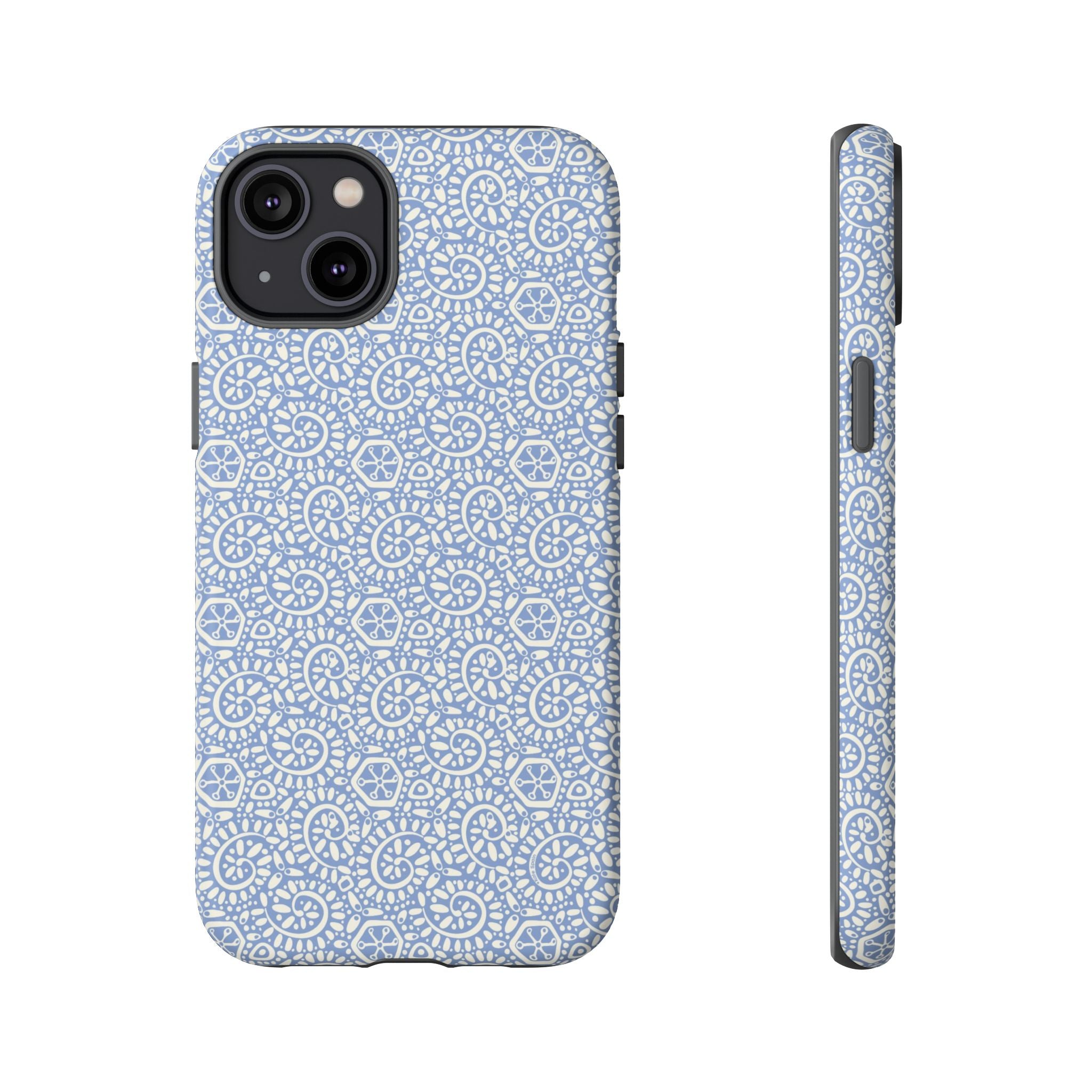 Canto Swirls Mist iPhone 14 Plus Matte Case — periwinkle blue hard case covered in an intricate folk-art medallion pattern of radiating white circular motifs, dot clusters, and geometric centers