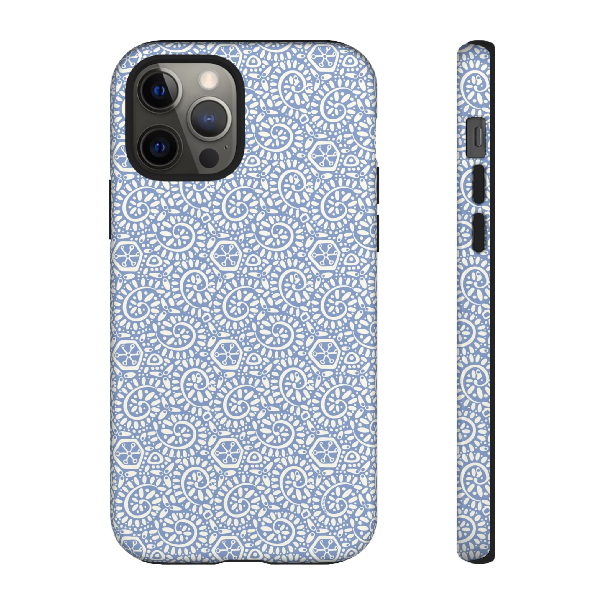 Canto Swirls Mist iPhone 12 Pro Glossy Case — periwinkle blue hard case covered in an intricate folk-art medallion pattern of radiating white circular motifs, dot clusters, and geometric centers