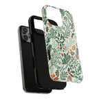 Juniper MagSafe iPhone 16 Pro Max Case – Dual-layered view of case and inner lining in front of phone, with view of camera cutout and buttons | cream, forest green, sage, and rust winter botanical print with pine, holly, acorns, and pinecones