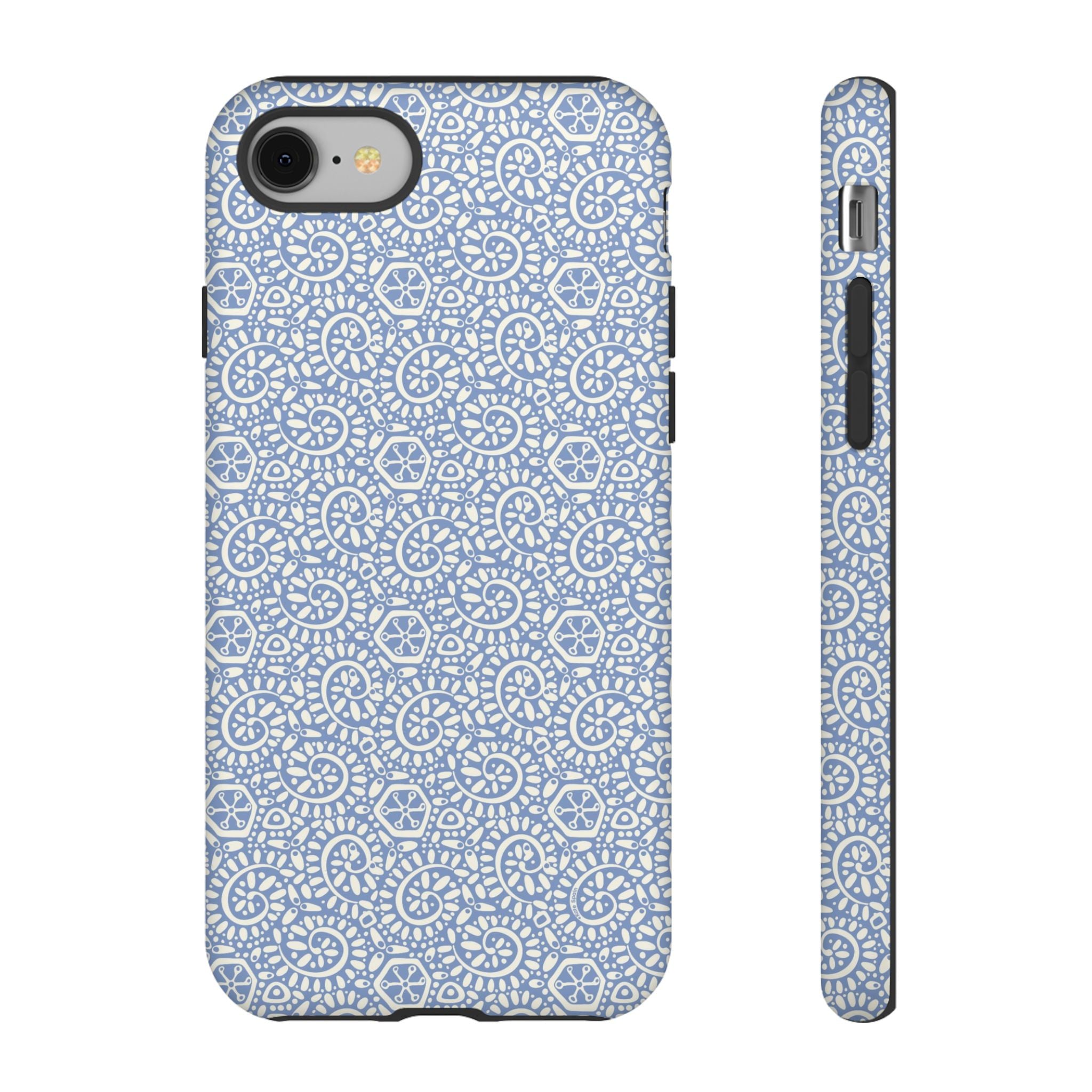 Canto Swirls Mist iPhone 8 Matte Case — periwinkle blue hard case covered in an intricate folk-art medallion pattern of radiating white circular motifs, dot clusters, and geometric centers