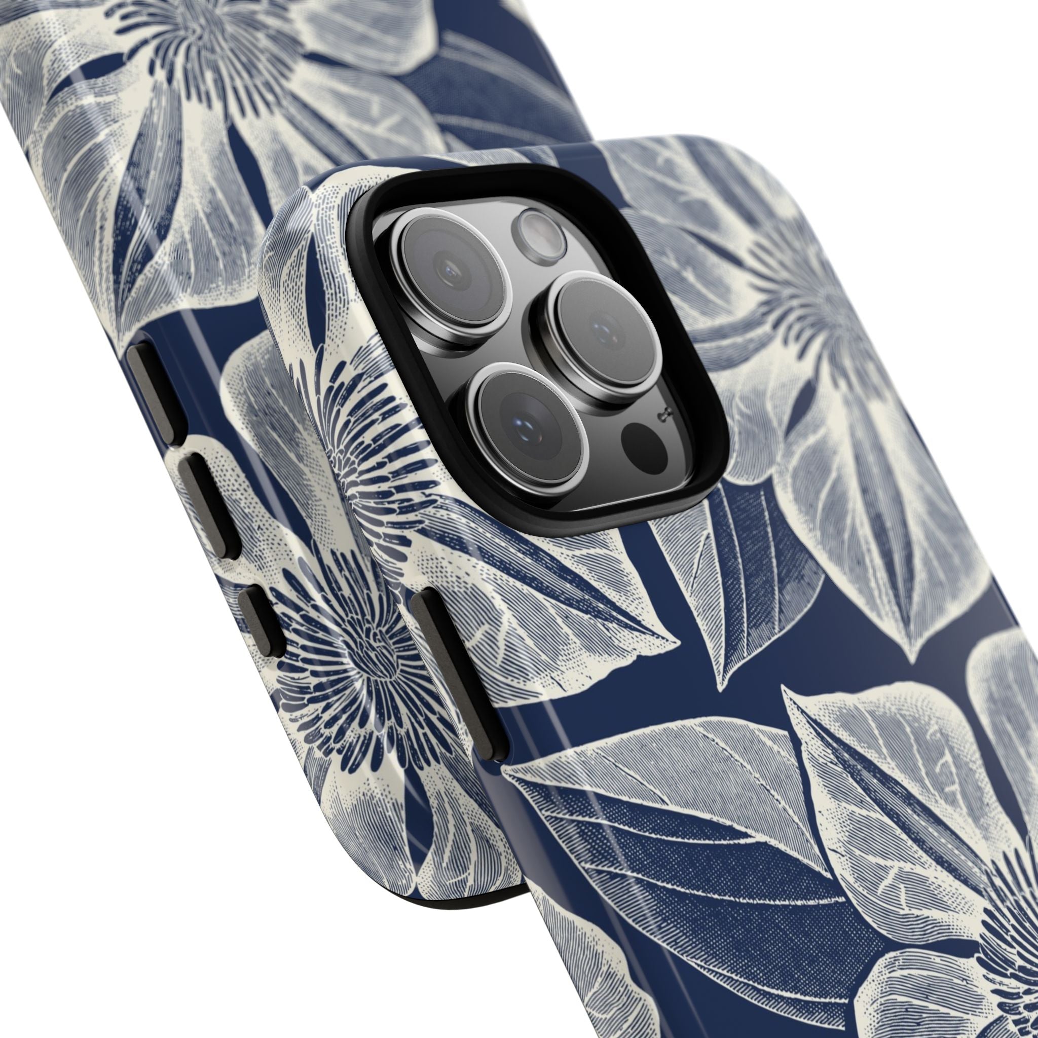 Vintage Bloom Navy iPhone 16 Pro Max case – Glossy | navy ground, large-scale cream clematis print, angled view showing camera cutout and buttons, dual-layer protection