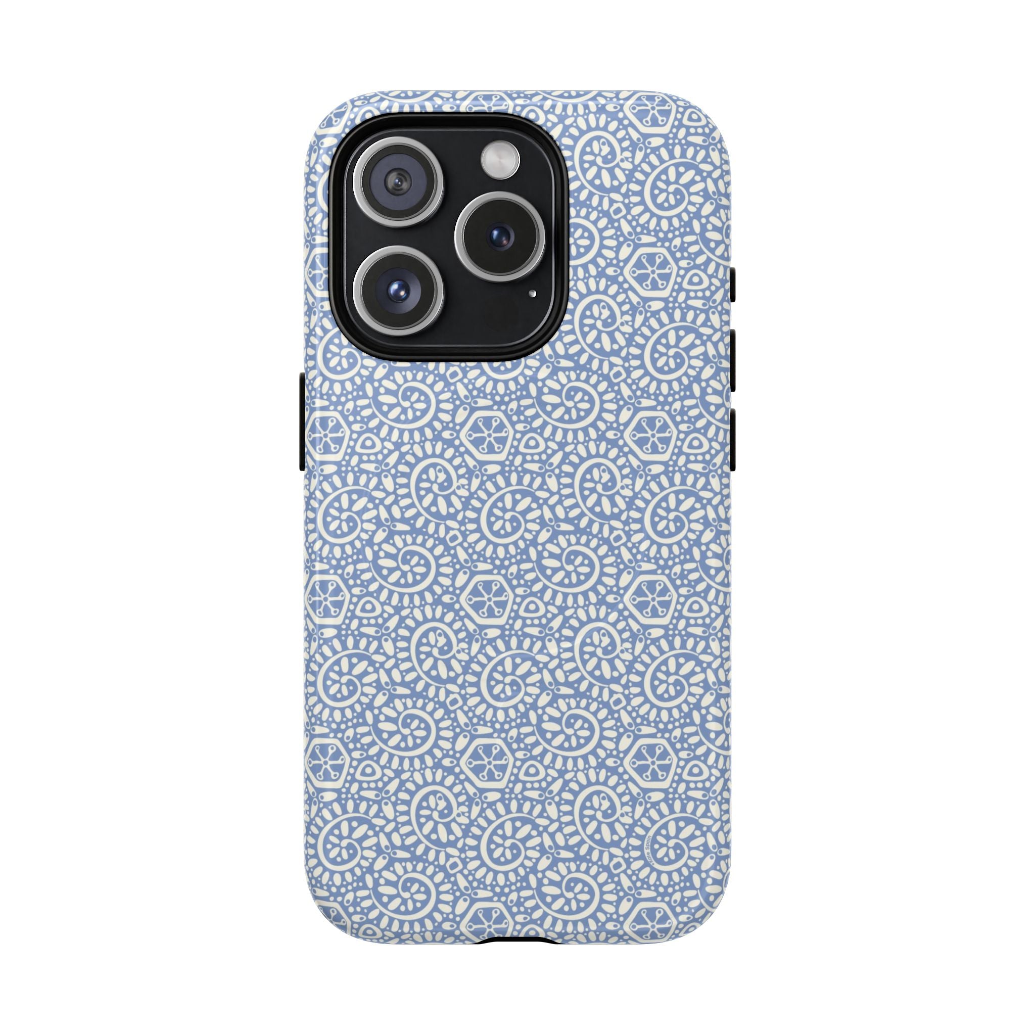Canto Swirls Mist MagSafe iPhone 15 Pro Glossy Case — periwinkle blue hard case covered in an intricate folk-art medallion pattern of radiating white circular motifs, dot clusters, and geometric centers