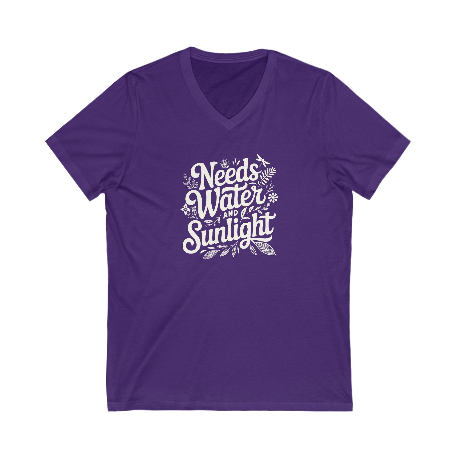 Saturated purple colored vneck t-shirt with white words that say 'Needs Water and Sunlight' in script style text with dragonfly, flower and leaf illustrations around the words.