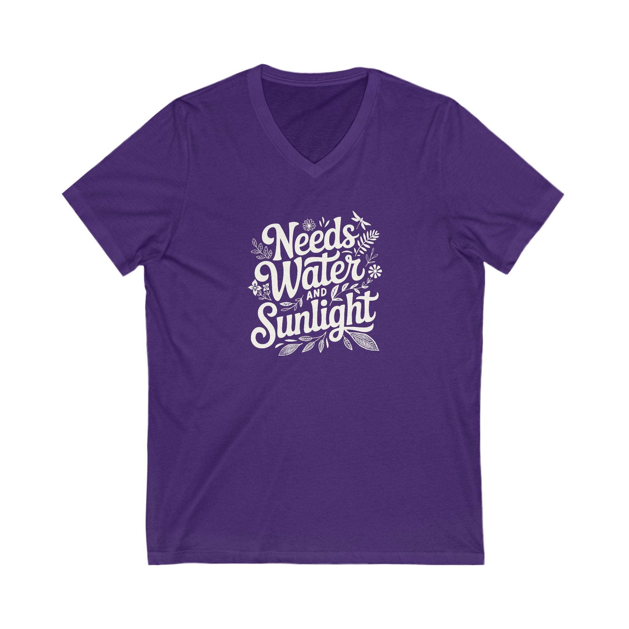 Saturated purple colored vneck t-shirt with white words that say 'Needs Water and Sunlight' in script style text with dragonfly, flower and leaf illustrations around the words.