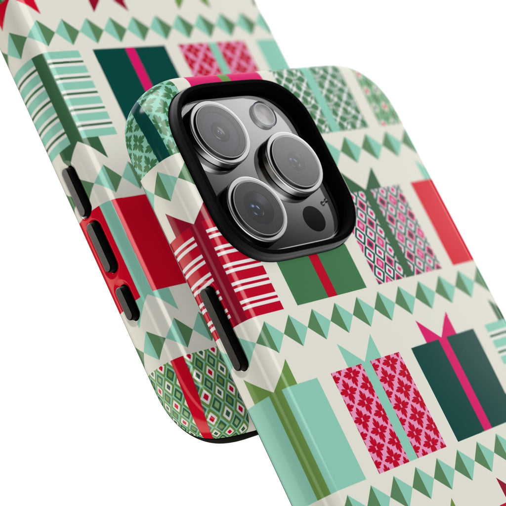 All Wrapped Up Tough iPhone 16 Pro Max Case – lifestyle angled view | cream, red, pink, green, mint geometric gift wrap holiday print