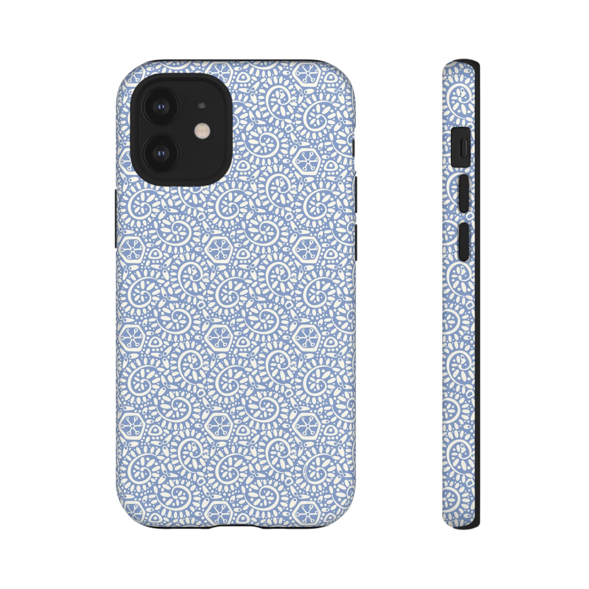 Canto Swirls Mist iPhone 12 Mini Glossy Case — periwinkle blue hard case covered in an intricate folk-art medallion pattern of radiating white circular motifs, dot clusters, and geometric centers