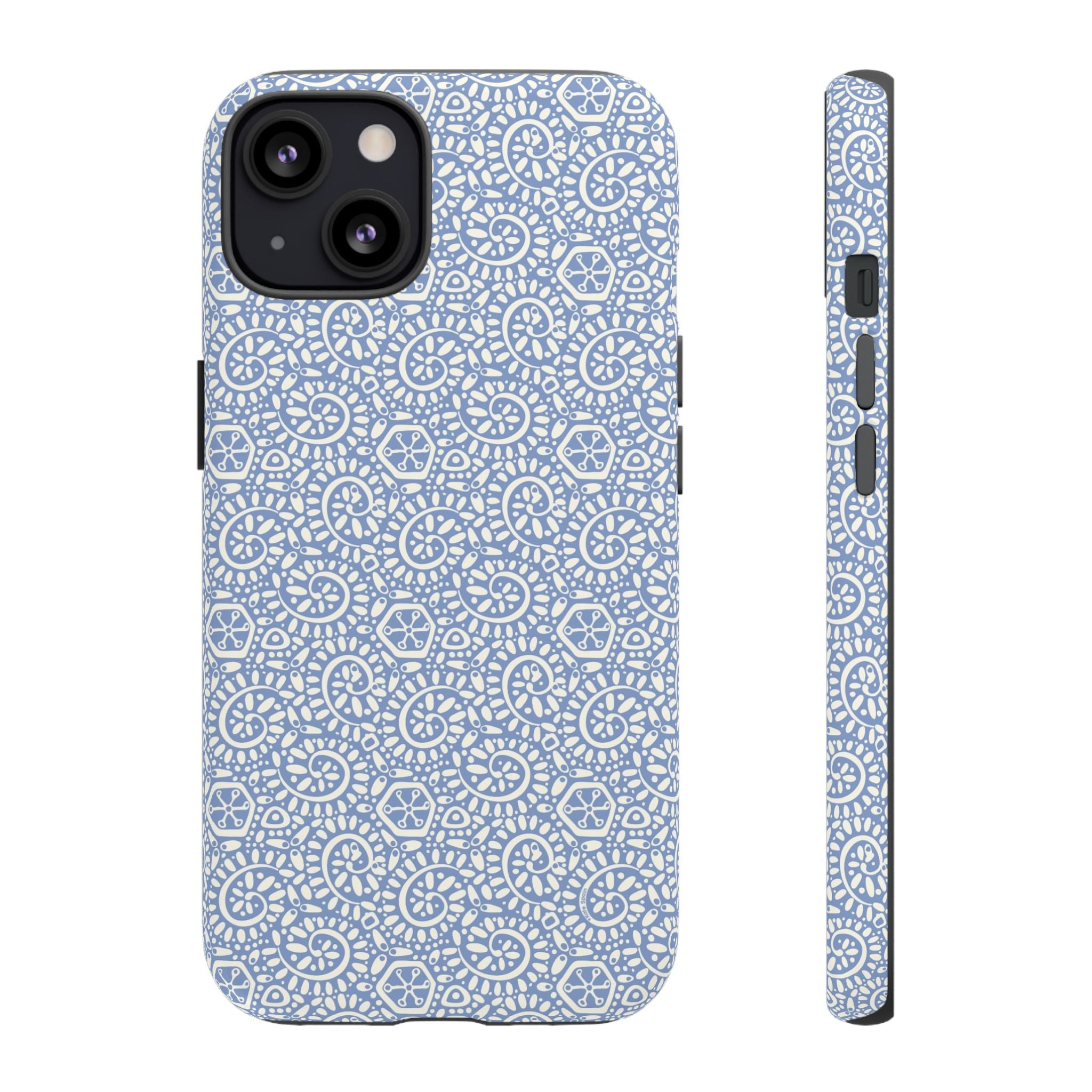 Canto Swirls Mist iPhone 13 Matte Case — periwinkle blue hard case covered in an intricate folk-art medallion pattern of radiating white circular motifs, dot clusters, and geometric centers
