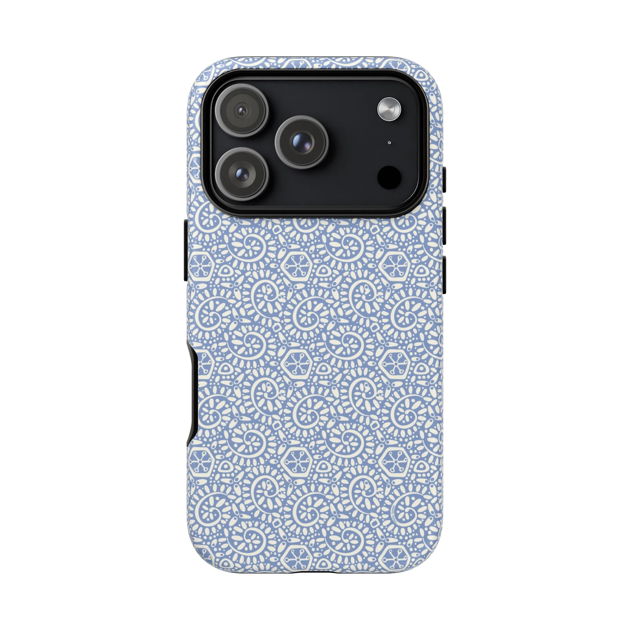 Canto Swirls Mist iPhone 17 Pro Matte Case — periwinkle blue hard case covered in an intricate folk-art medallion pattern of radiating white circular motifs, dot clusters, and geometric centers
