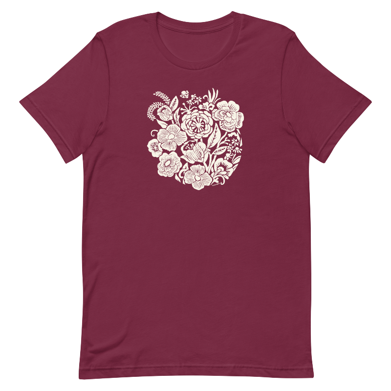 Maroon t-shirt with a white floral design on a white background